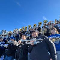 trumpet alumni in the stands